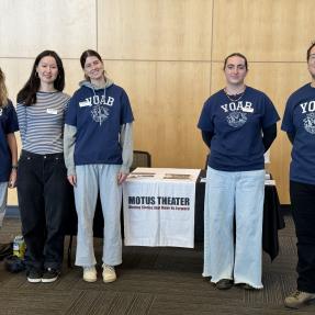 Four YOAB volunteers pose with Youth Opportunities Project Manage Mario Martinez-Varelas at a Motus Theater event. 