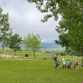 Campers following staff at a park