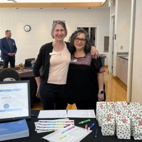 City staff members posing behind the welcome table for the event