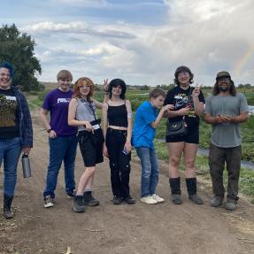 Group of youth from Rocky Mountain Equality pose at the farm.