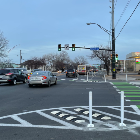 paint and post protecvted interim intersection with green bike crossing and pedestrian crossings in white paint