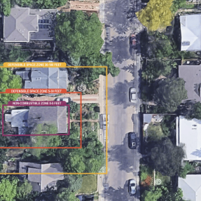 Suburban neighborhood with three concentric defensible space zones overlaid on a single home.