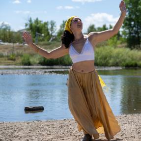 Afro-Brazilian dancer by a small pond