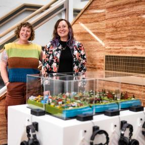 Artists standing behind their project in the Penfield Tate Municipal Building lobby