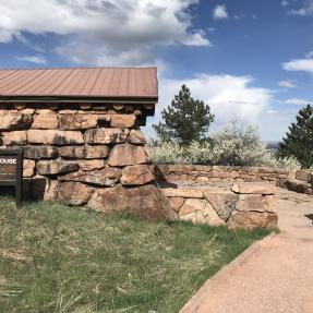 A wide, gravel trail leads to the Halfway House flagstone patio, with the Halfway House on the left.