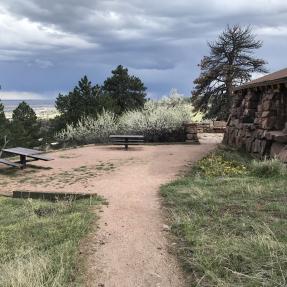 A gravel trail leads to the outdoor picnic area on the east side of the Halfway House