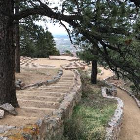 Stone steps on the left and a ramp on the right lead down to the Sunrise Amphitheater.