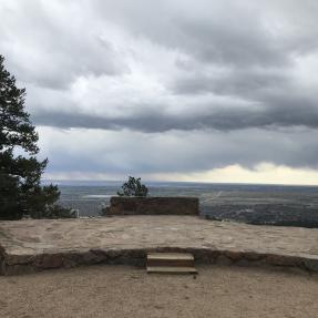 The Sunrise Amphitheater stone stage with a view down to Boulder in the background.