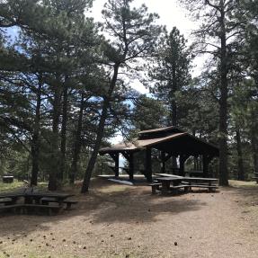 The Wood Shelter, a covered, open-sided shelter with picnic tables.