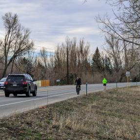 people biking and walking on 28th Street (US 36) roadway shoulder