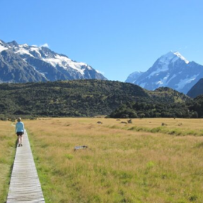  Elizabeth Judd on a mountain meadow boardwalk with peaks in the distance