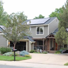 Home with solar panels and an open garage.