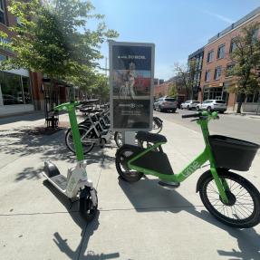 scooter and glider in front of a parking station in downtown boulder