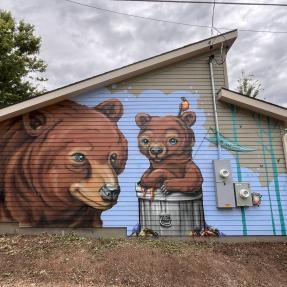Mural of two bears on the side of a garage