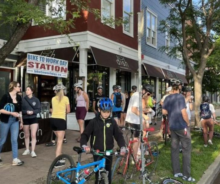 Community members and their bikes at a Bike to Work Day station